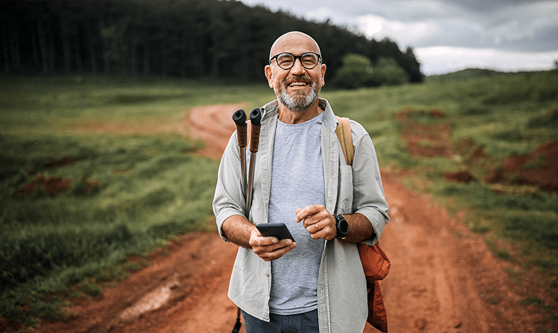 Happy man walking along track