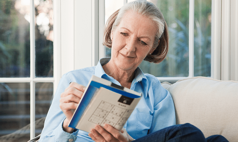 Older woman doing sudoku