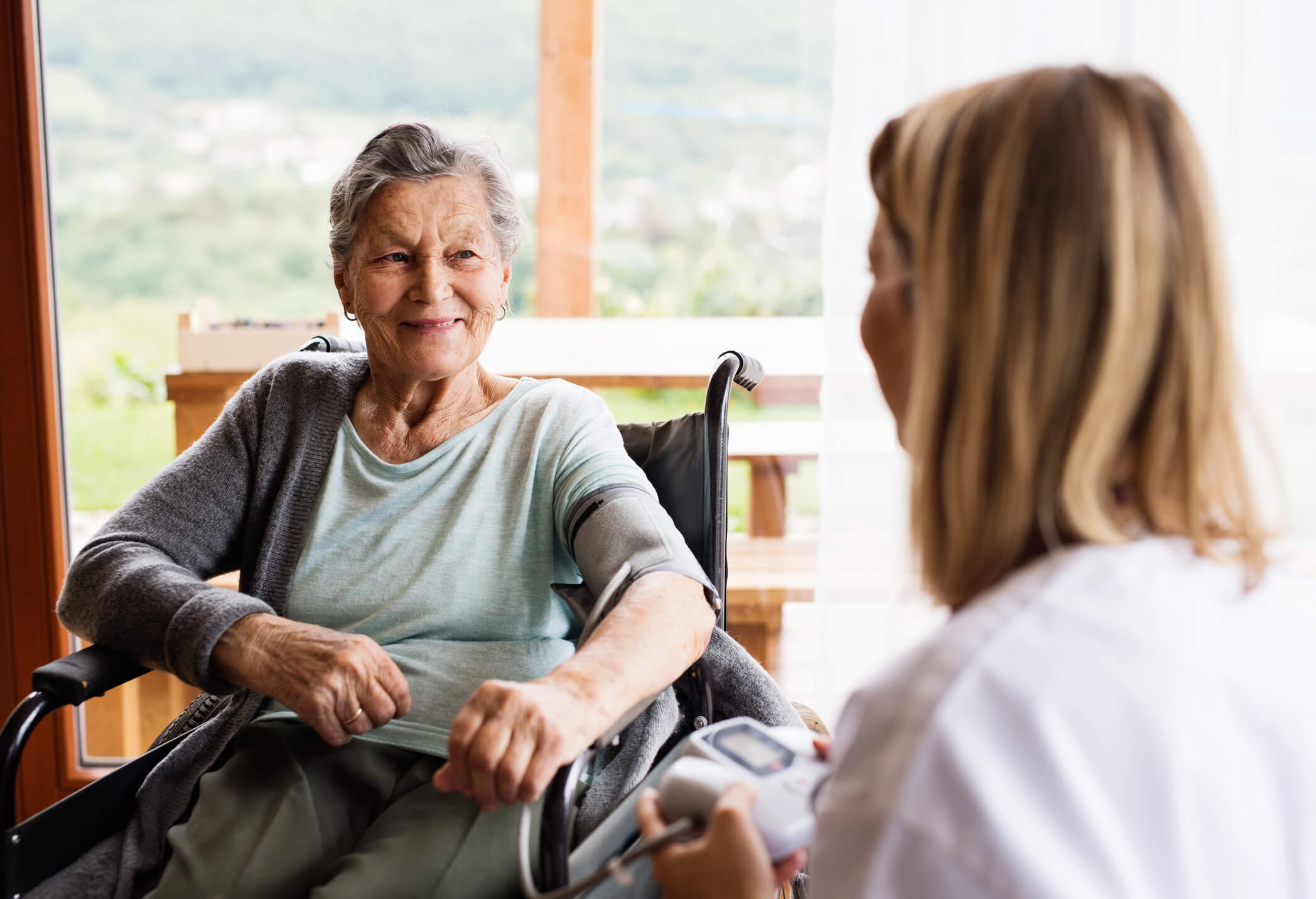 Older woman chatting to a nurse