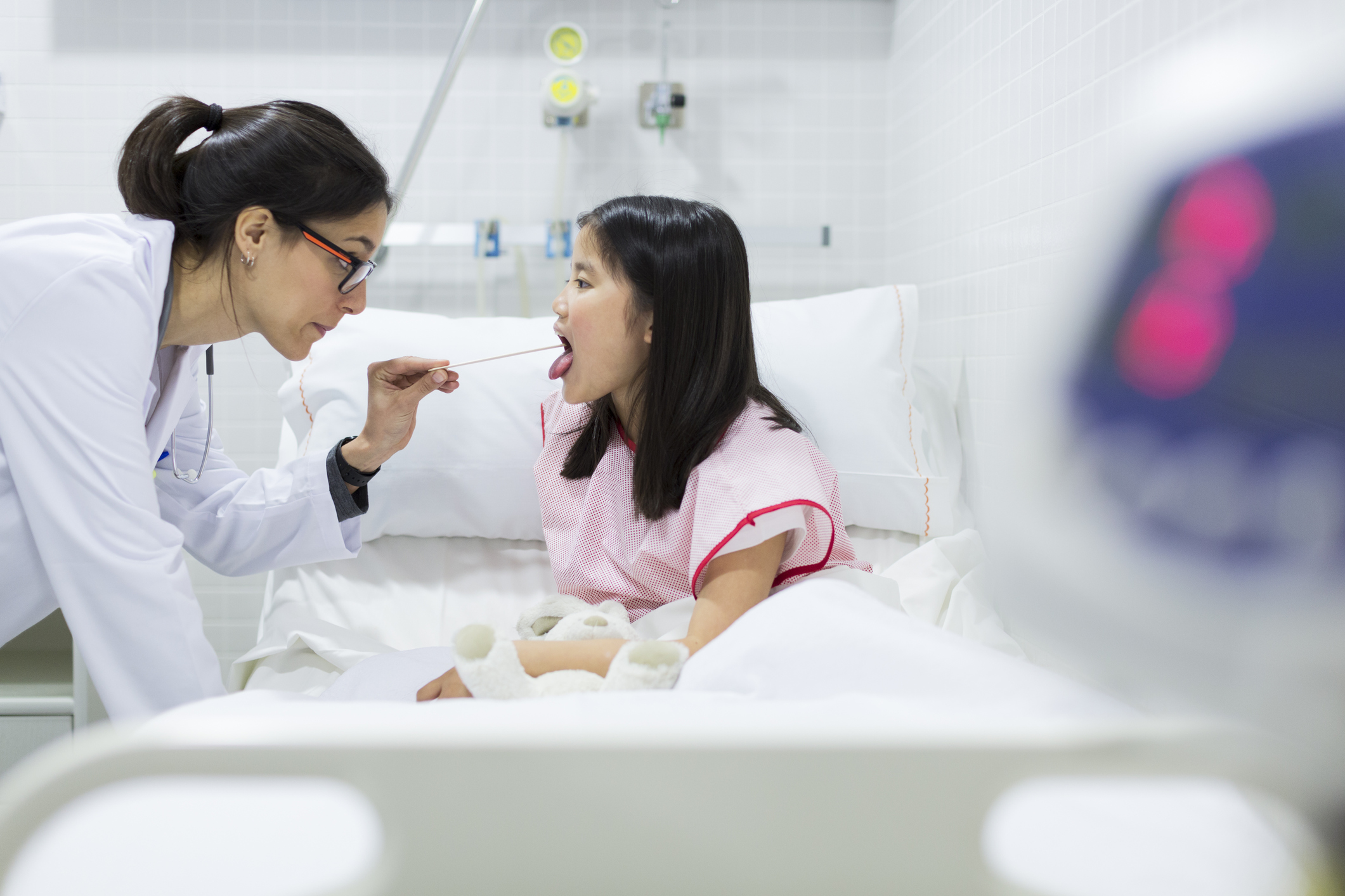 Doctor looking into child's mouth Doctor looking into child's mouth