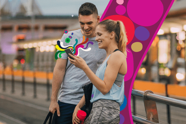 Couple looking at phone on bridge