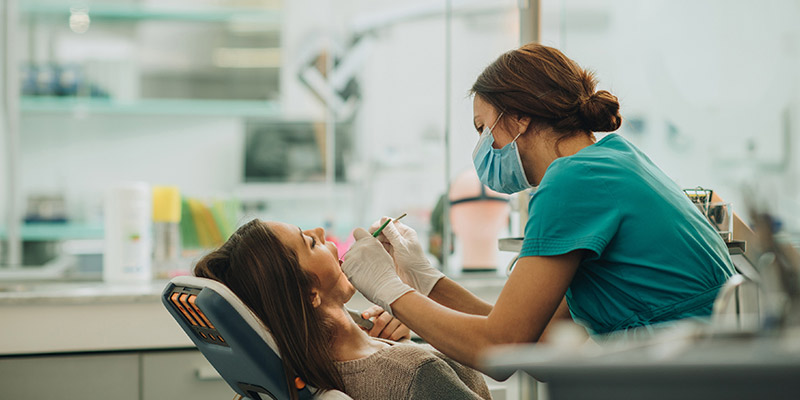 a woman in a dentist chair a woman in a dentist chair