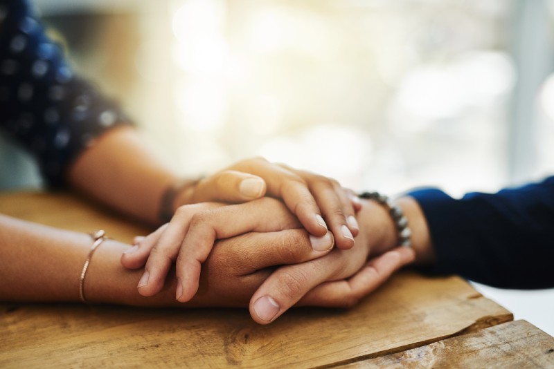 Someone holding another person's hand in support