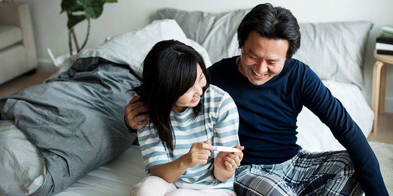 A couple with a pregnancy test A couple with a pregnancy test