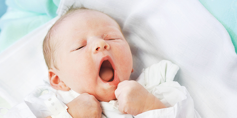 A newborn baby yawning A newborn baby yawning