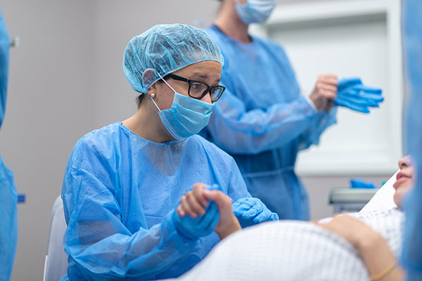 Health professional holding hand of pregnant woman in hospital Health professional holding hand of pregnant woman in hospital