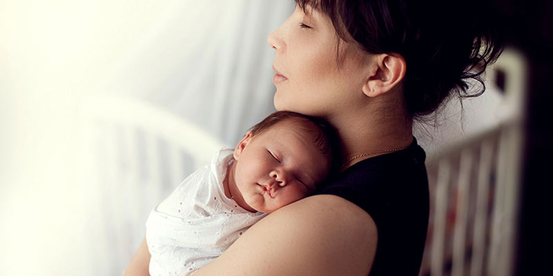 A mum cuddling her newborn baby A mum cuddling her newborn baby