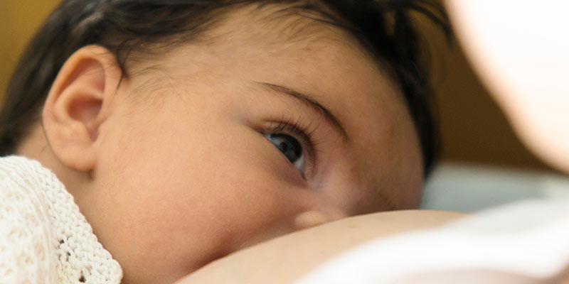 A close-up of a baby being breast-fed A close-up of a baby being breast-fed