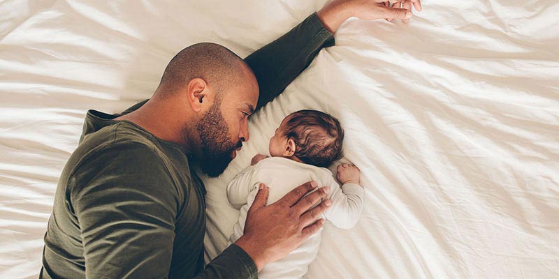 A father and baby cuddling A father and baby cuddling