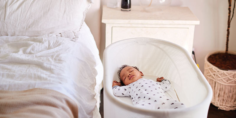 A sleeping baby in a bassinet A sleeping baby in a bassinet