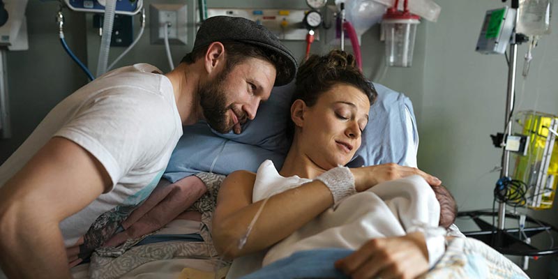 A couple at hospital with their newborn baby A couple at hospital with their newborn baby