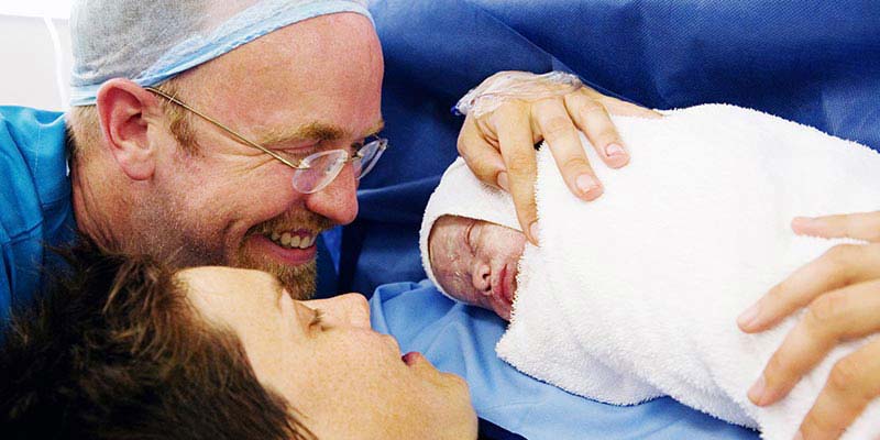 A couple with their newborn baby A couple with their newborn baby