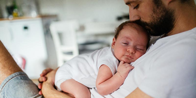 father cuddling newborn baby father cuddling newborn baby