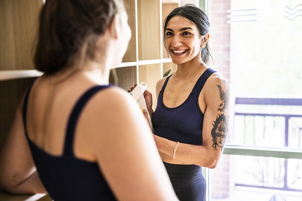 Female yoga students talking after yoga class