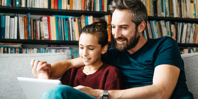 Father and daughter reading together