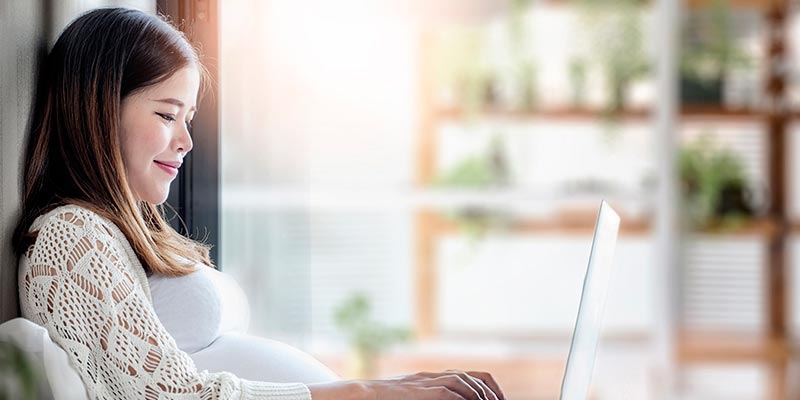 A pregnant woman on her laptop A pregnant woman on her laptop